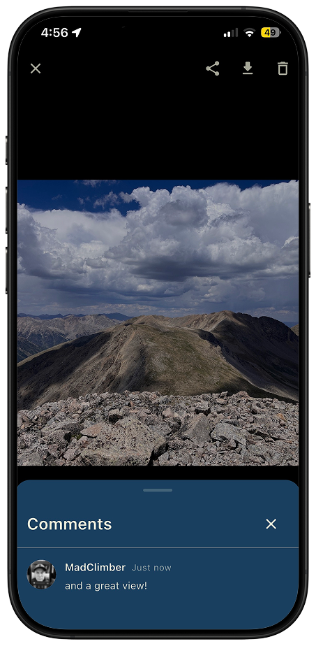 Thred full-screen photo of a mountain summit ridge with the Comments drawer open below it showing a comment from MadClimber